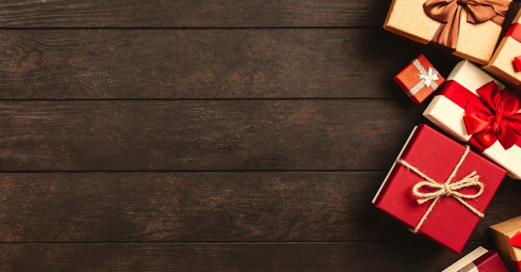Decorative holiday gift boxes with ribbons on a rustic wooden surface, perfect for seasonal themes.