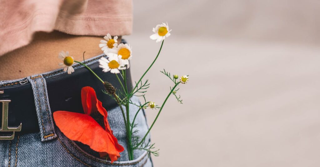 Close-up of wildflowers in a denim pocket, showcasing casual fashion and nature.