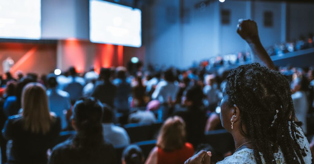 Vibrant crowd at a conference with a focus on an attentive participant.