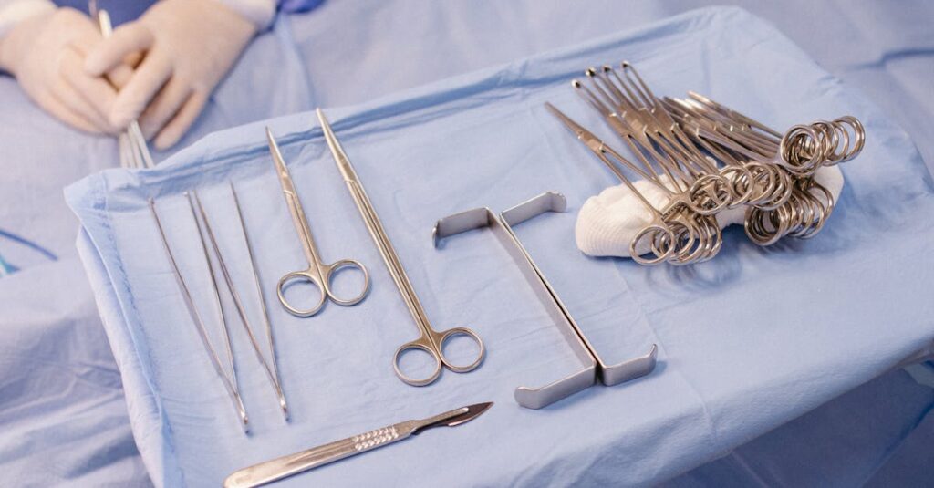 A set of surgical instruments carefully arranged on a blue drape during an operation.