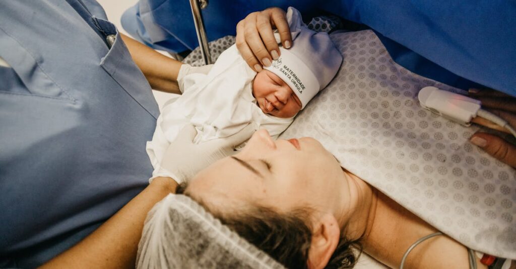 A mother cradling her newborn immediately after childbirth in a hospital setting.