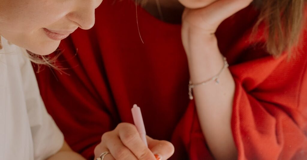 Two college students studying together, focusing on exam preparation in a bright setting.