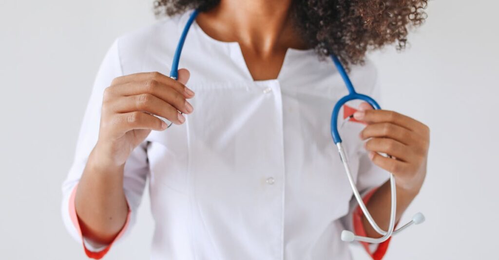 A female doctor holds a stethoscope, focusing on healthcare professionalism.