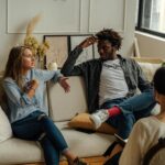 A couple is engaged in a lively conversation during a therapy session with a counselor.