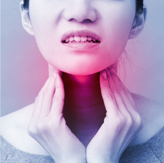 Black and white photo of a woman holding her thyroid and a red glow emanating from her thyroid area